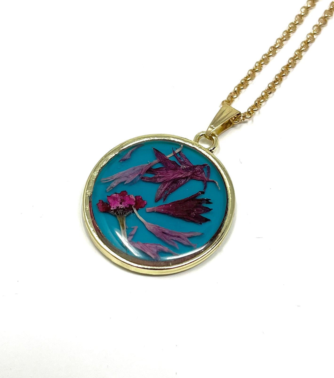 Round Necklace with Hand Pressed Wild Flowers on a Blue Base