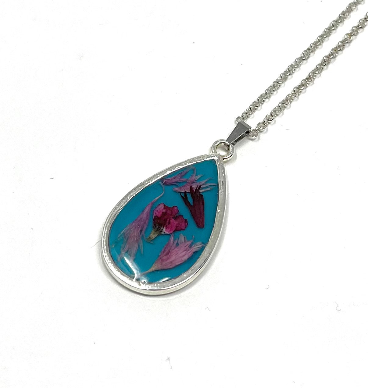 Teardrop Necklace with pressed Wild Flowers on a Blue Base